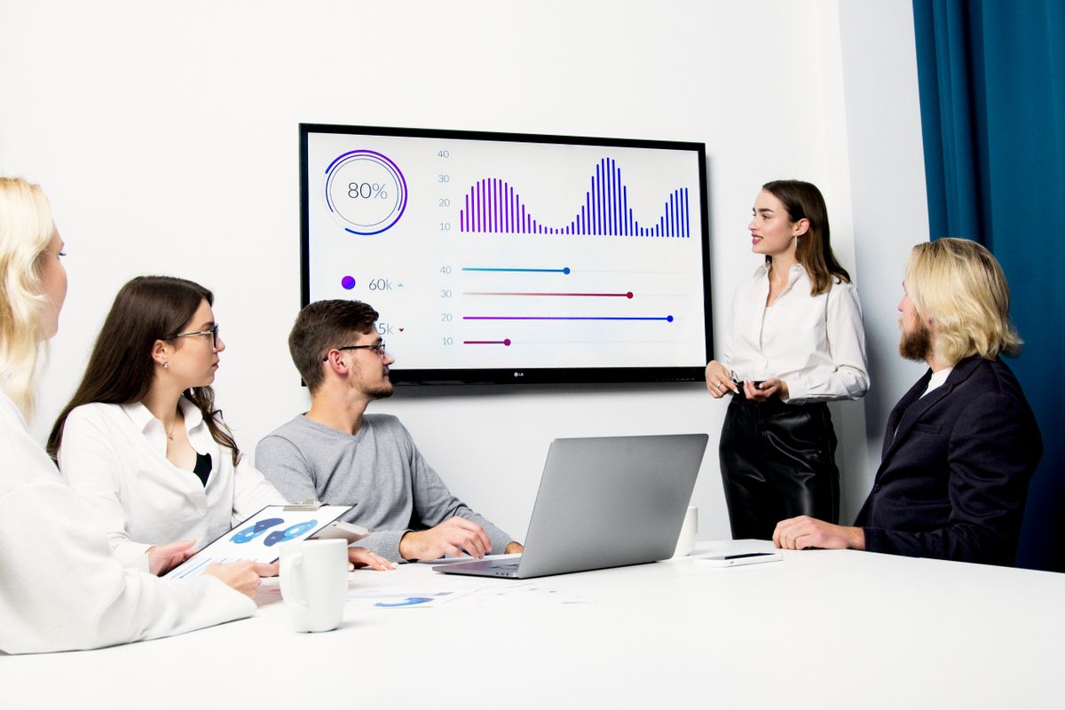 A team going over figures on screen