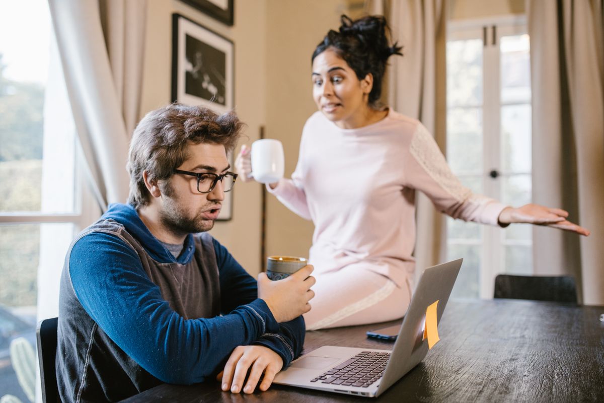 Two people working together on a laptop at home